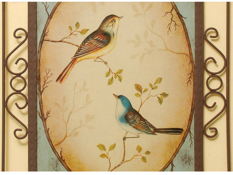 Two blue and yellow metal lover birds wall art pieces.