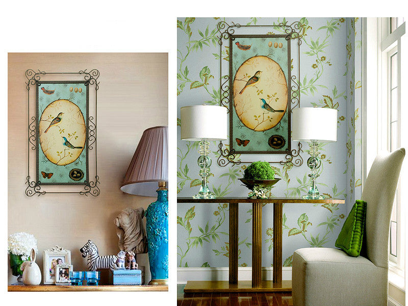 Two blue and yellow metal lover bird wall art pieces.