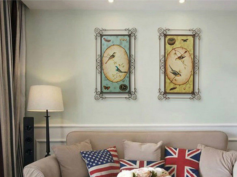 Two blue and yellow metal love birds art pieces for wall decor.