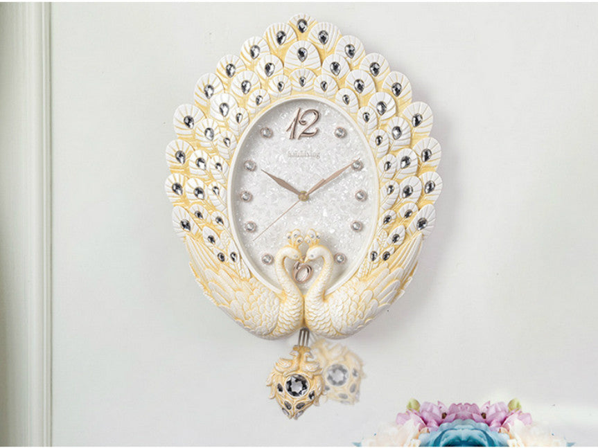 Dancing peacock clock with pendulum, diamond face, and jeweled wings.