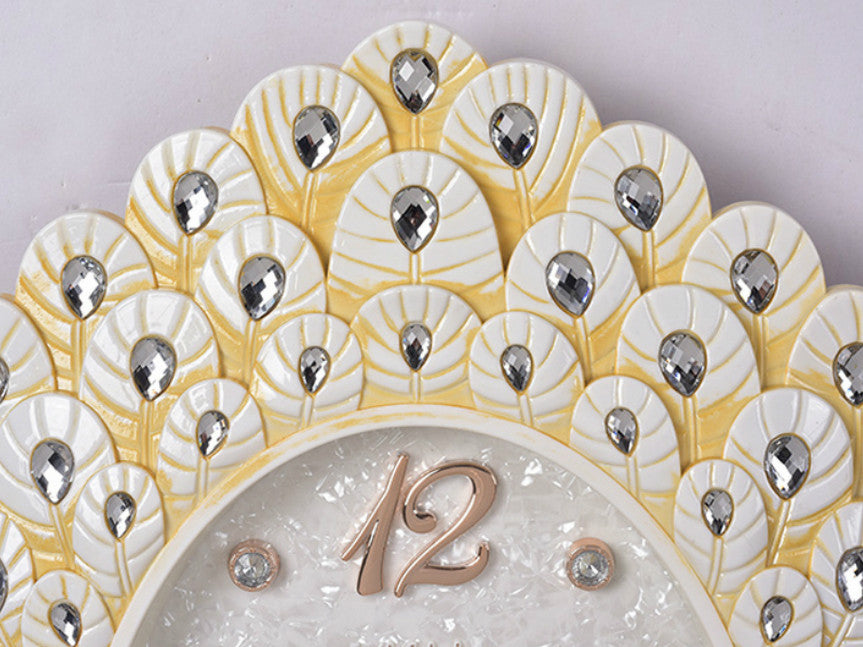Jeweled dancing peacock clock with pendulum and diamond face.