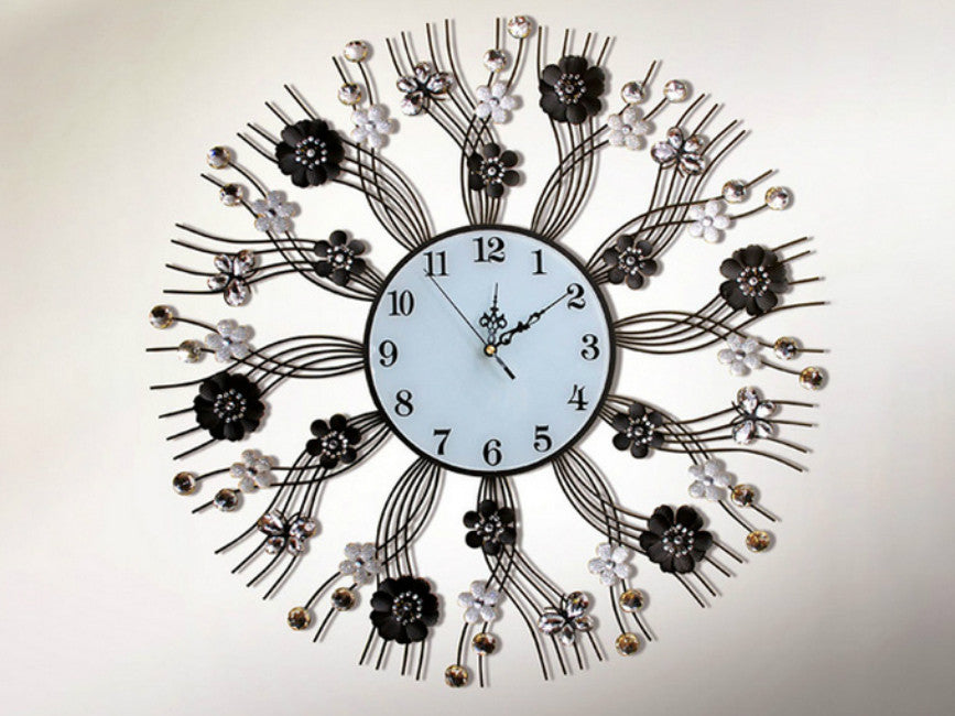 Black metallic wall clock with jewels and gothic butterfly design.