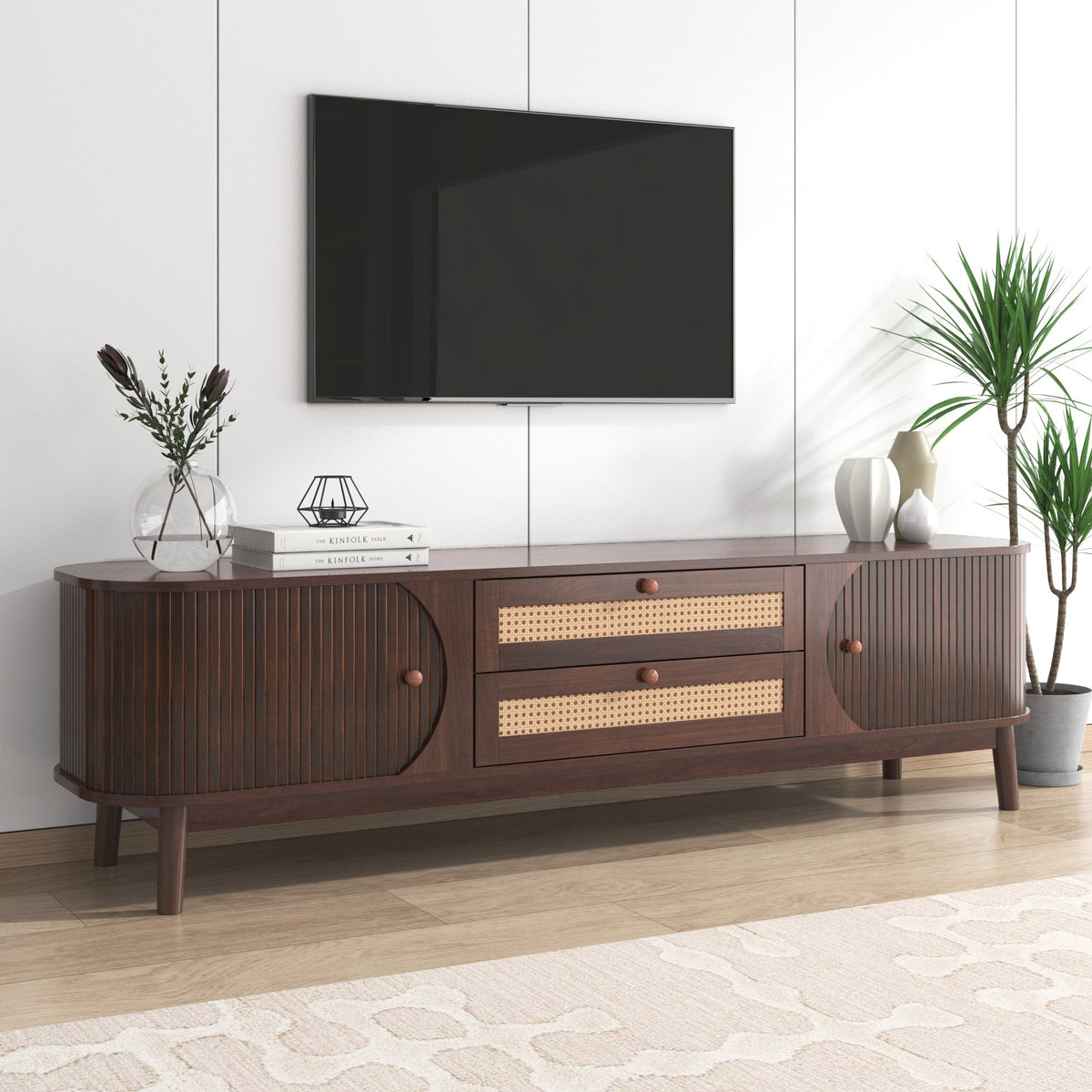 Modern farmhouse rattan TV stand in natural wood tone, holding a large TV.