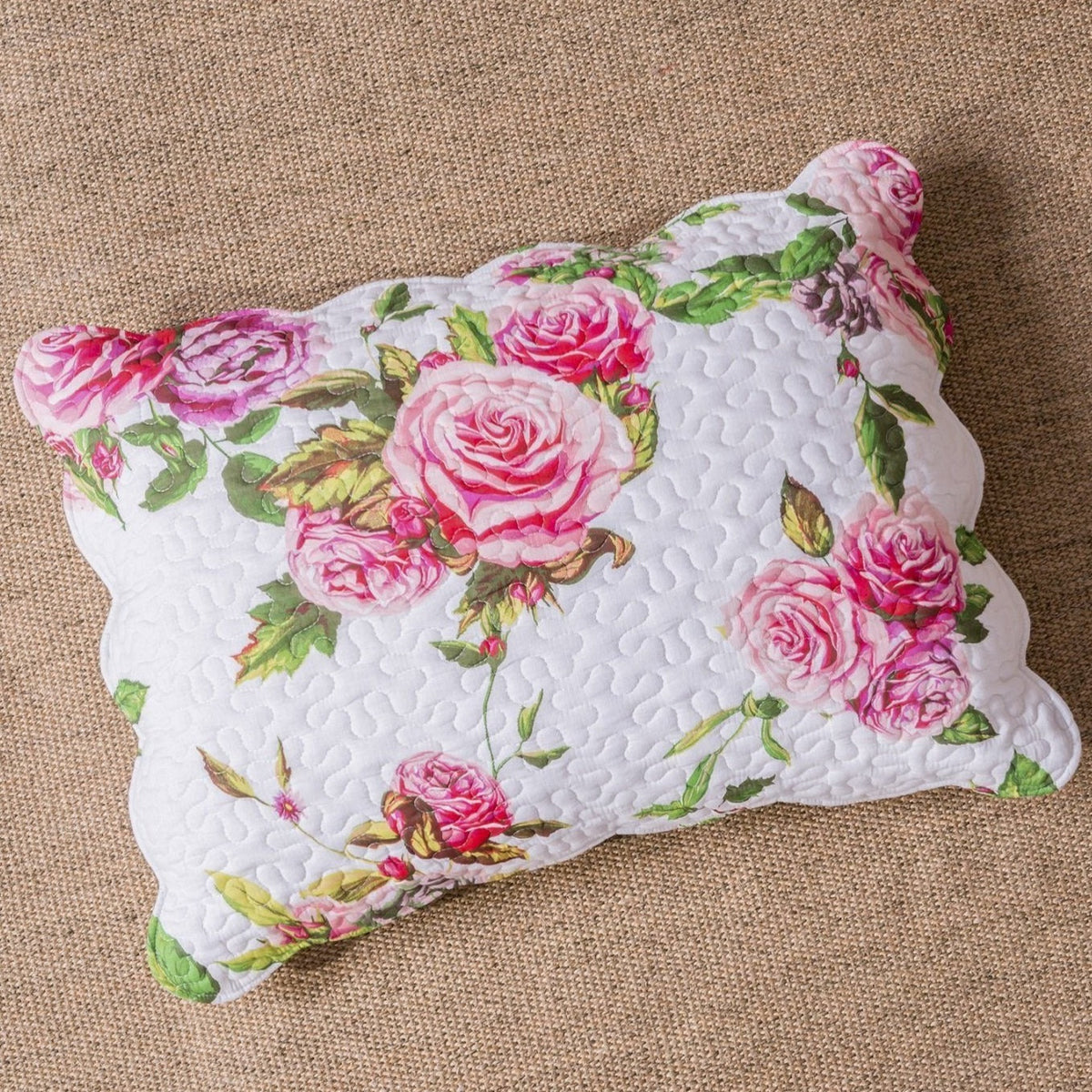 Pink floral quilted bedspread set with scalloped edges and romantic rose pattern.
