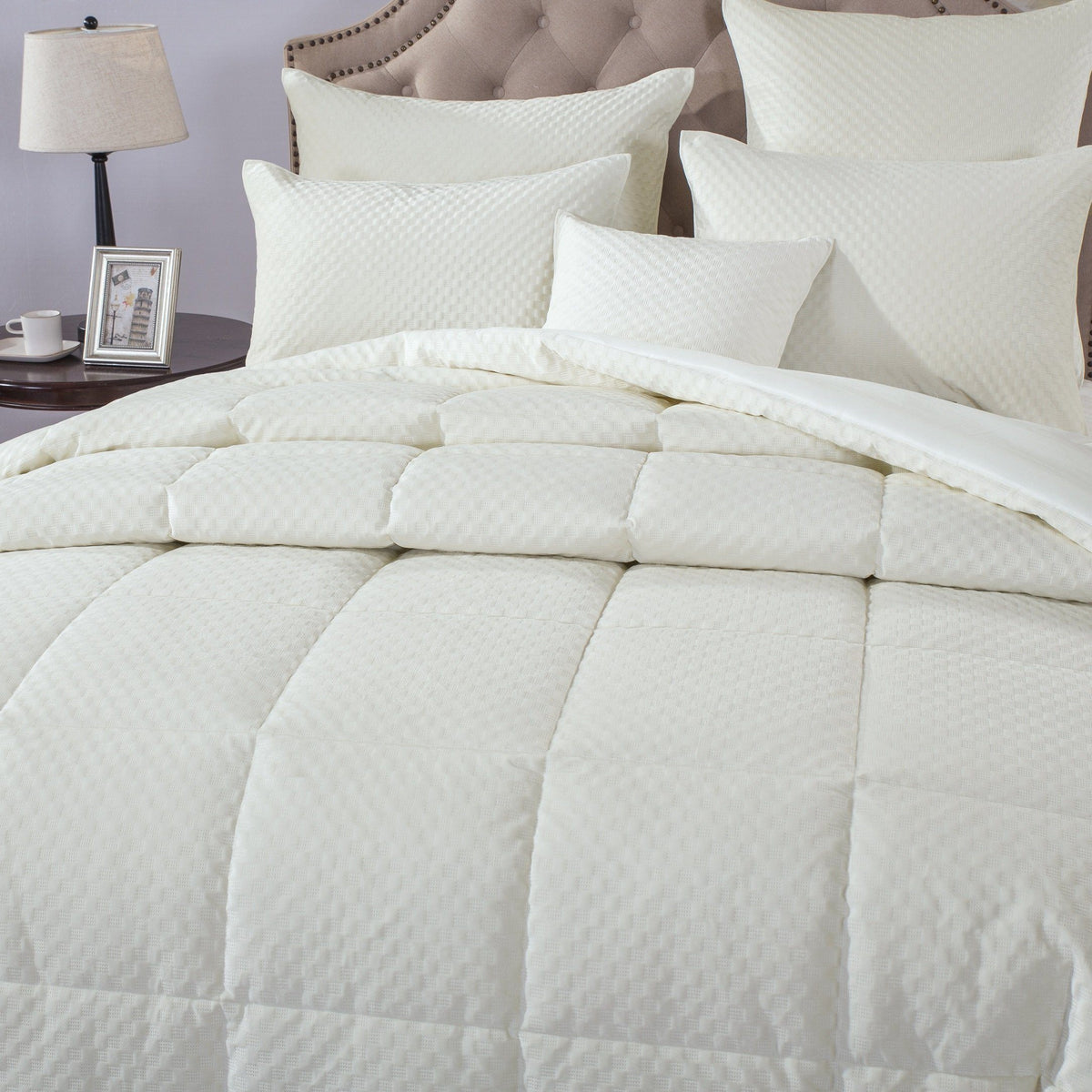 Ivory white velvet comforter set with tufted quilting detail.