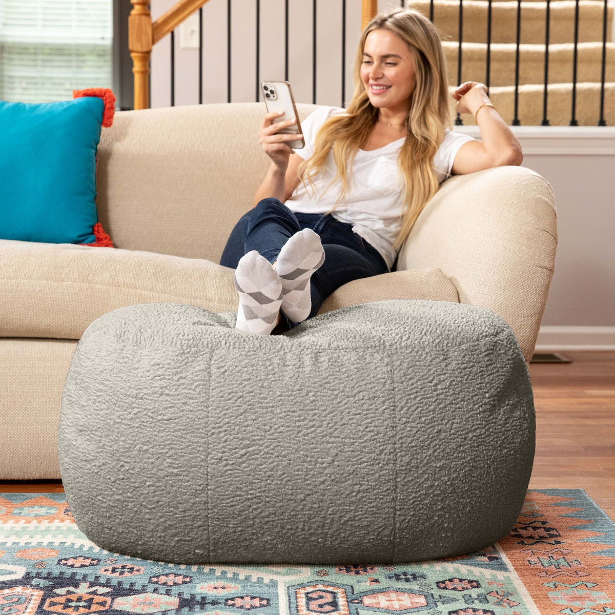 Jaxx Ellis oval ottoman in smoke faux shearling, soft and plush pouf.