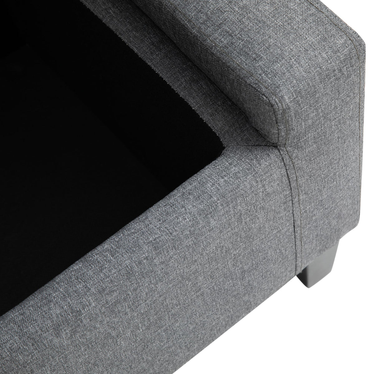 Gray linen storage ottoman with lift top, functions as footstool.
