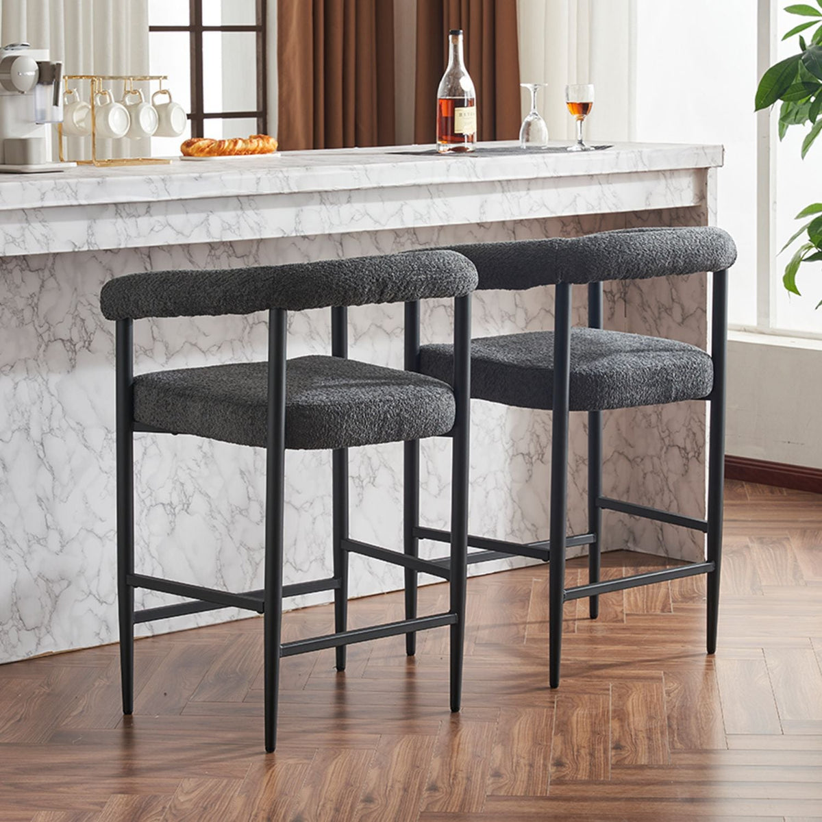 Two modern boucle upholstered bar stools in cream.