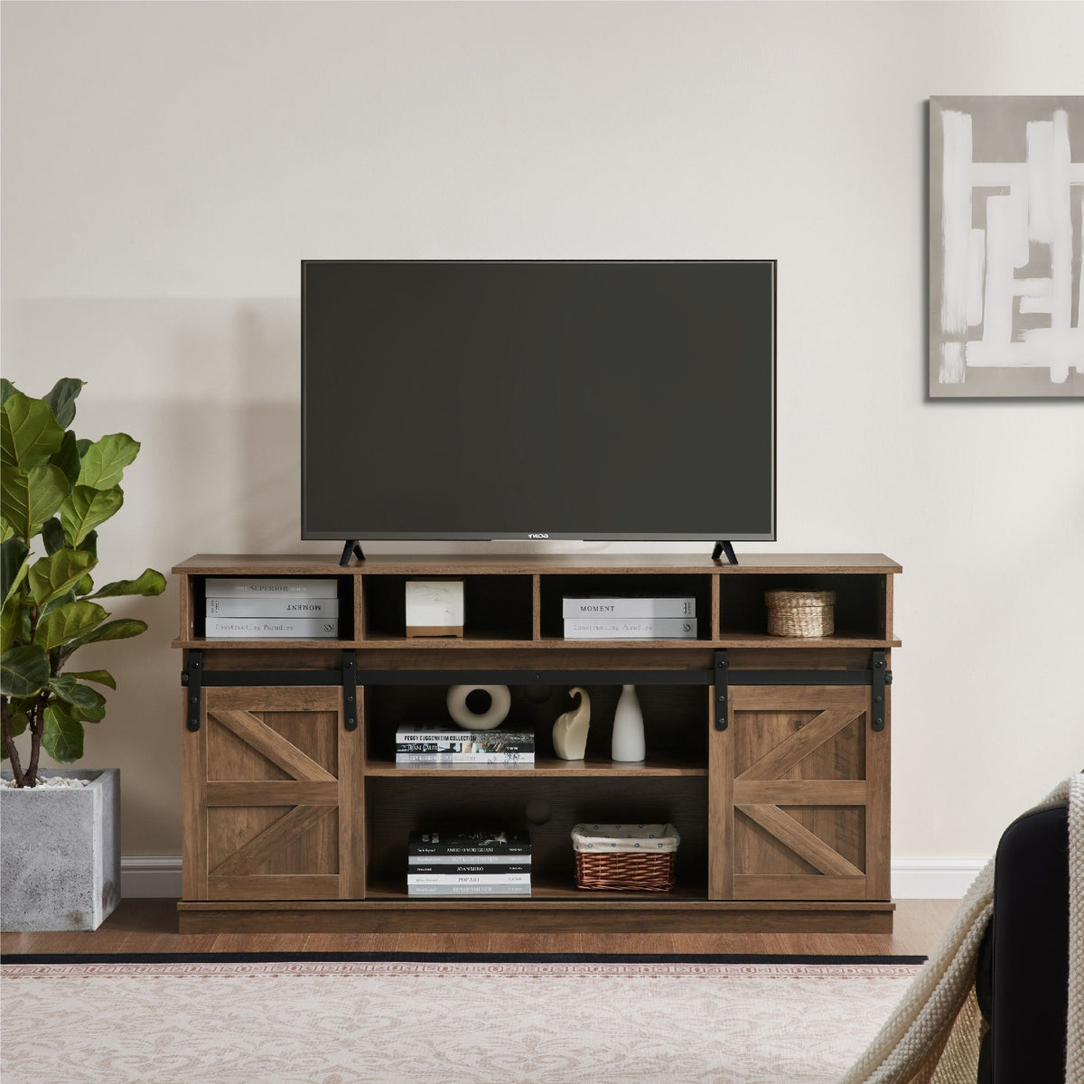 Natural brown farmhouse barn door TV stand with wood storage and farmhouse details.