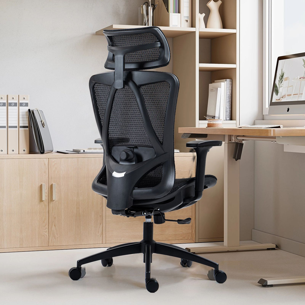 Ergonomic office chair with high back, mesh, adjustable headrest, lumbar support, and padded seat.