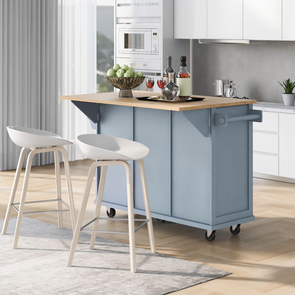 Kitchen cart with drop-leaf rubber wood top, 5 wheels, and cabinet drawers.
