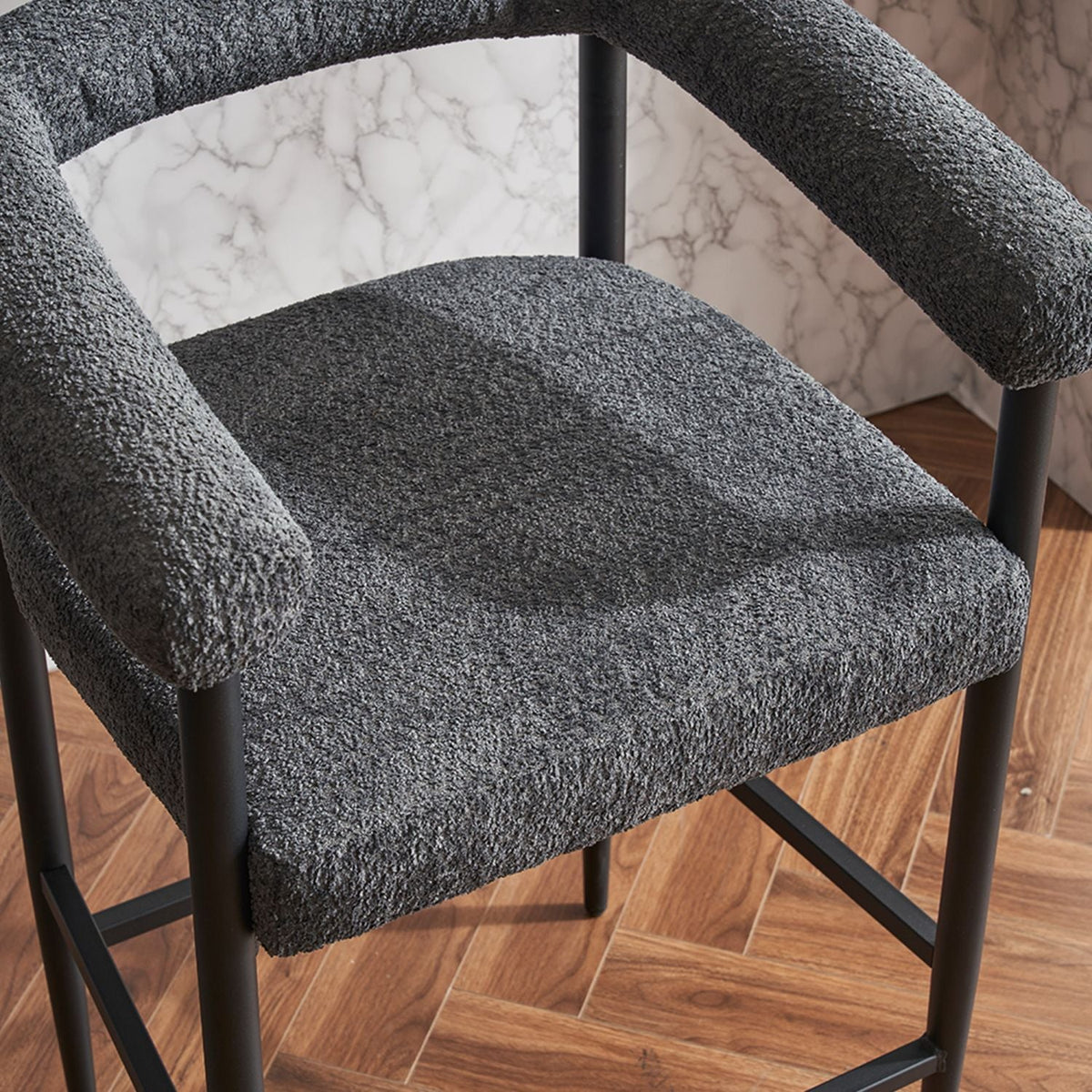 Two boucle fabric upholstered counter height bar stools.
