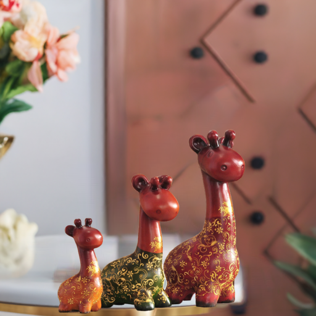 Hand-painted resin sculpture set of three colorful giraffes for table decor.