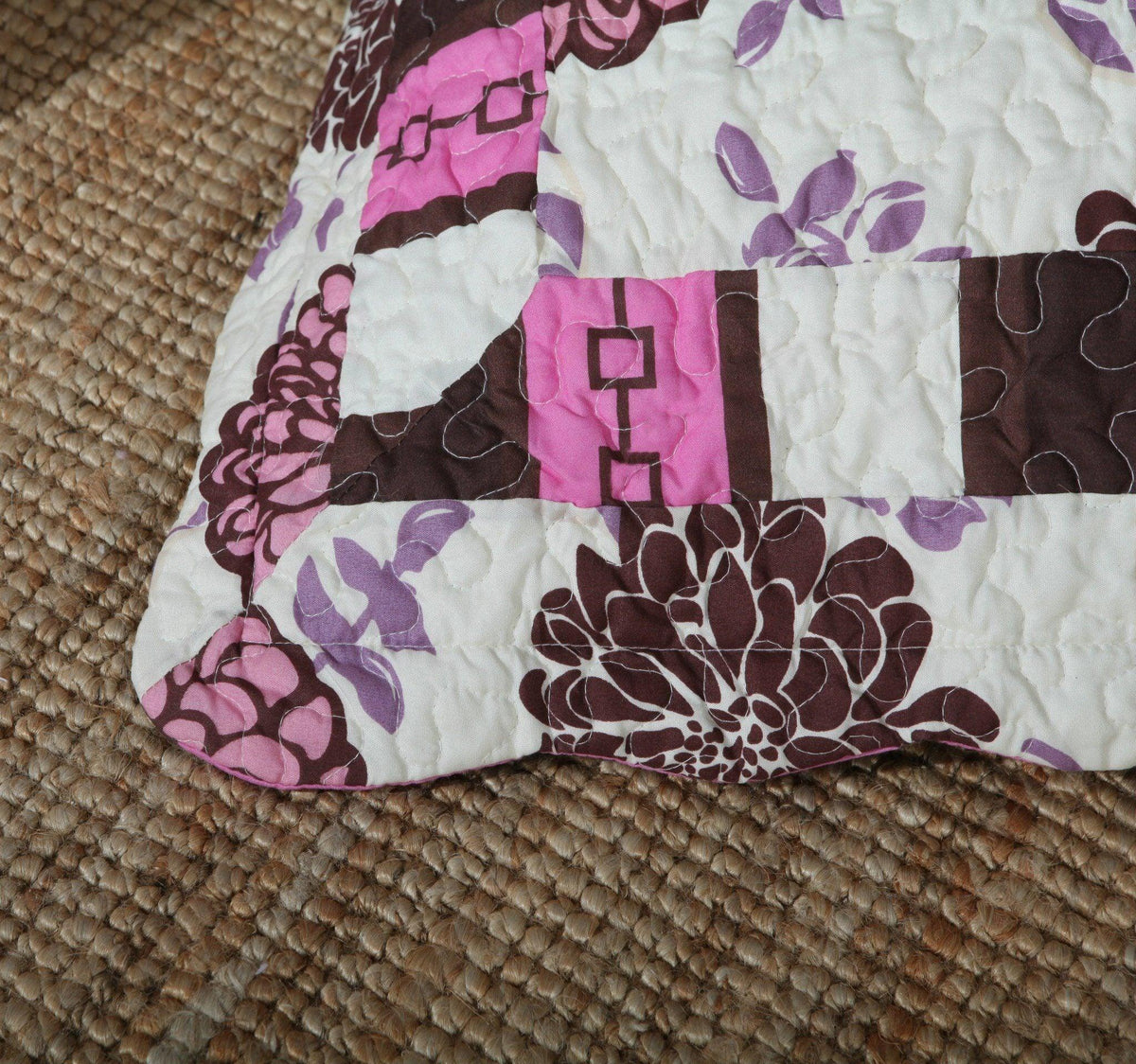 Bohemian purple floral bedspread set with pink and brown accents.