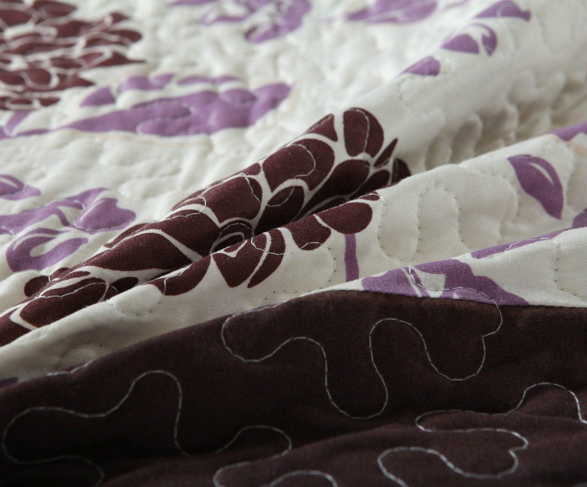 Bohemian purple floral bedspread set with pink and brown accents.
