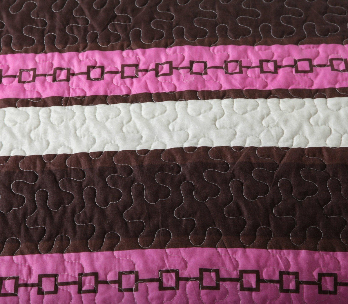 Bohemian purple floral bedspread set with pink and brown accents.