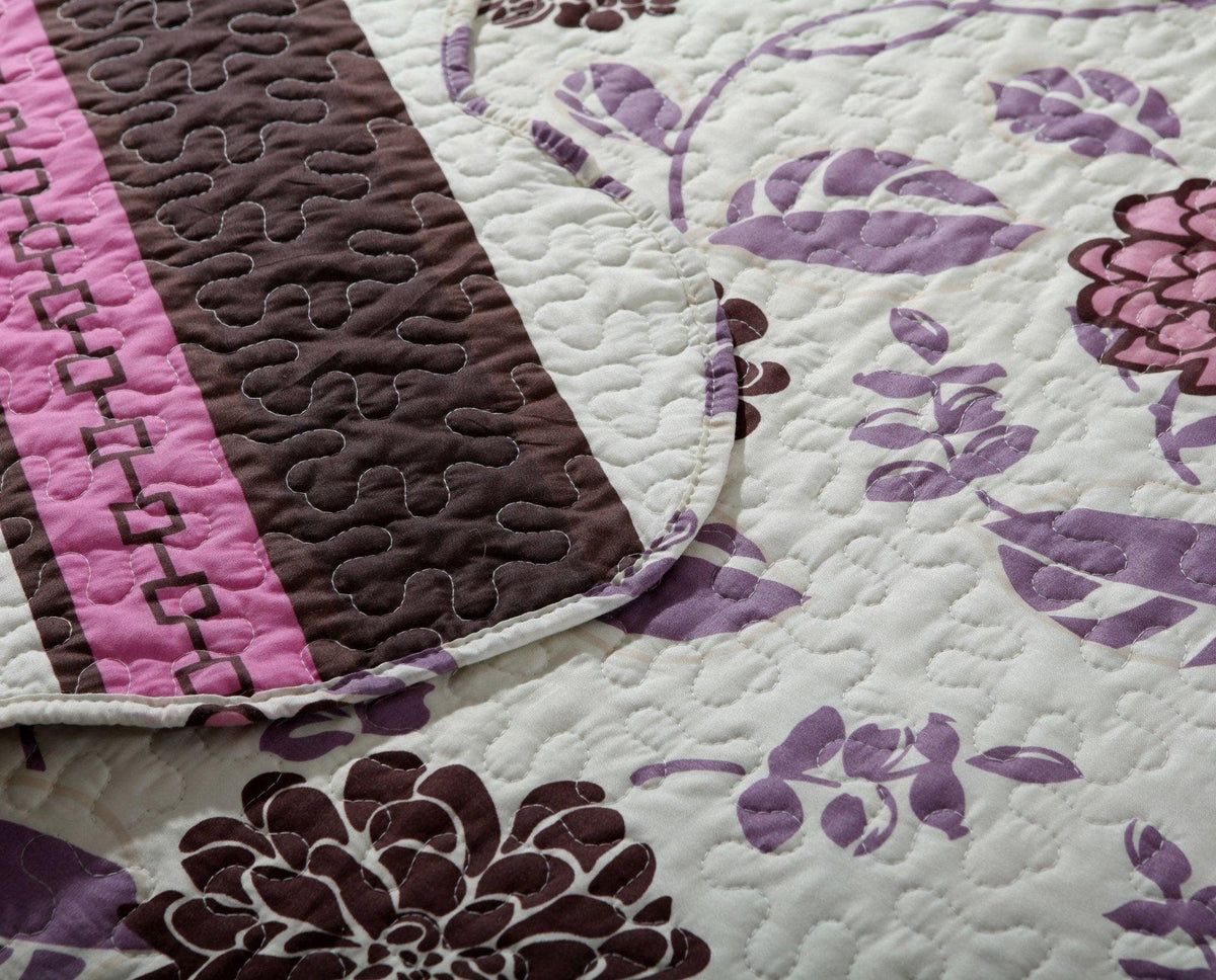 Bohemian purple, pink, and brown floral bedspread set with blooming flowers.