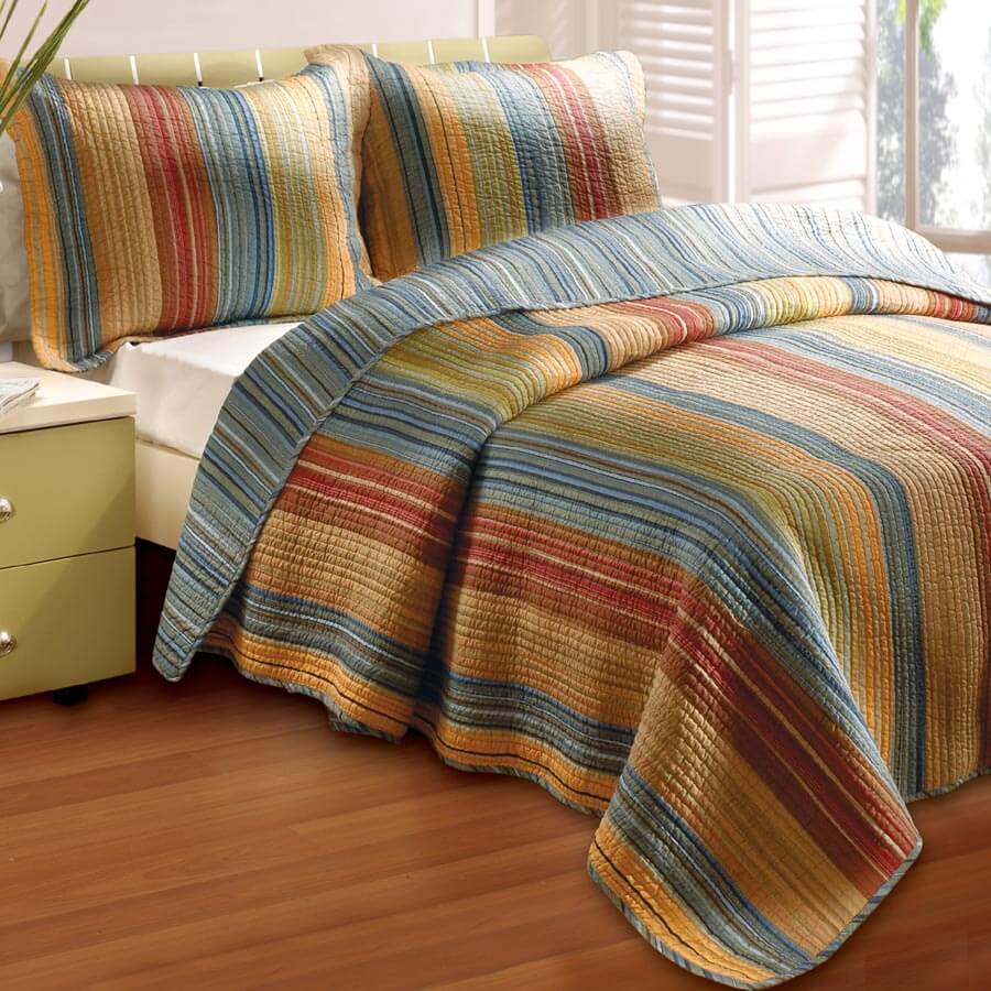 Transform your bedroom with Southwest Horizons Quilt Sets, featuring rich desert tones and classic striped patterns.