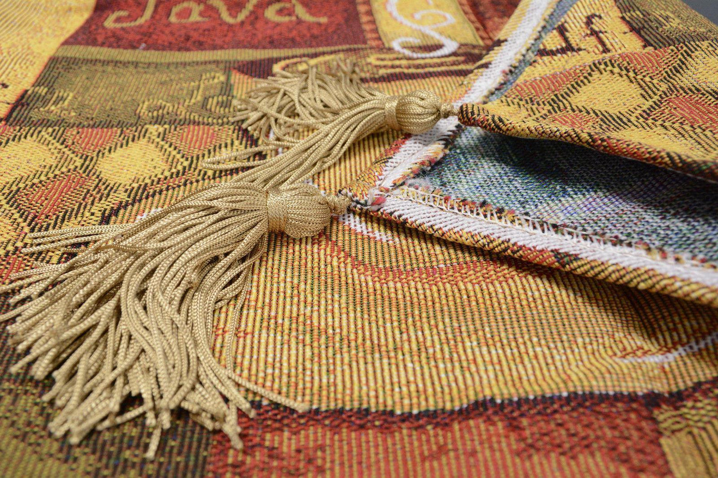 Brown tapestry table runner with latte java coffee cup design and gold tassels.